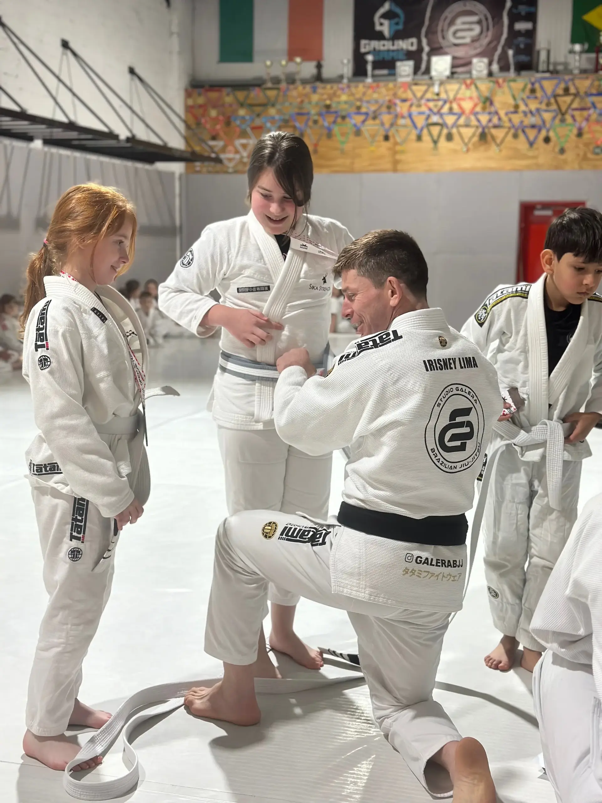 Students and instructors celebrating belt promotions at Studio Galera BJJ graduation in Bandon, West Cork 1