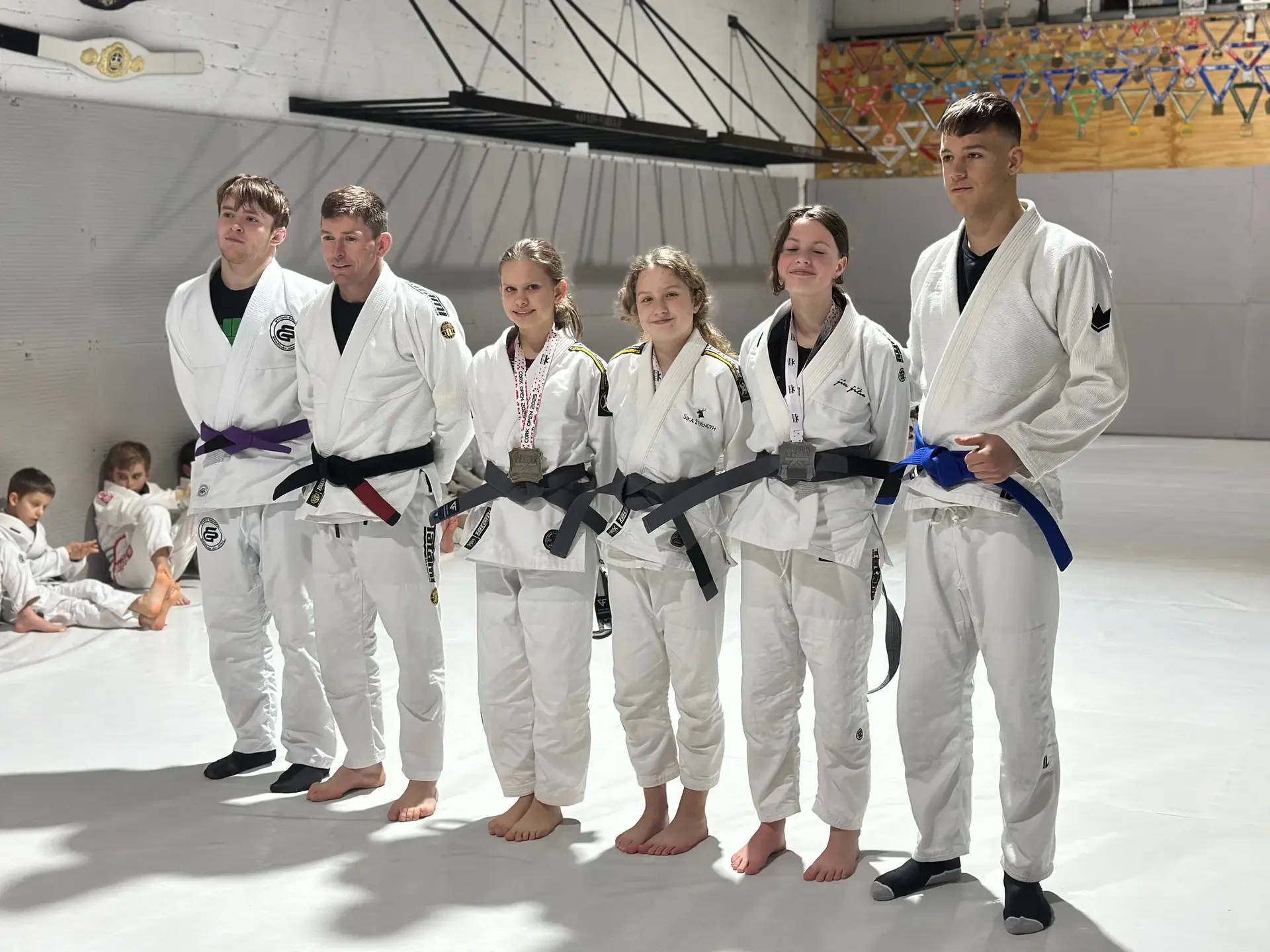 Students and instructors celebrating belt promotions at Studio Galera BJJ graduation in Bandon, West Cork 2
