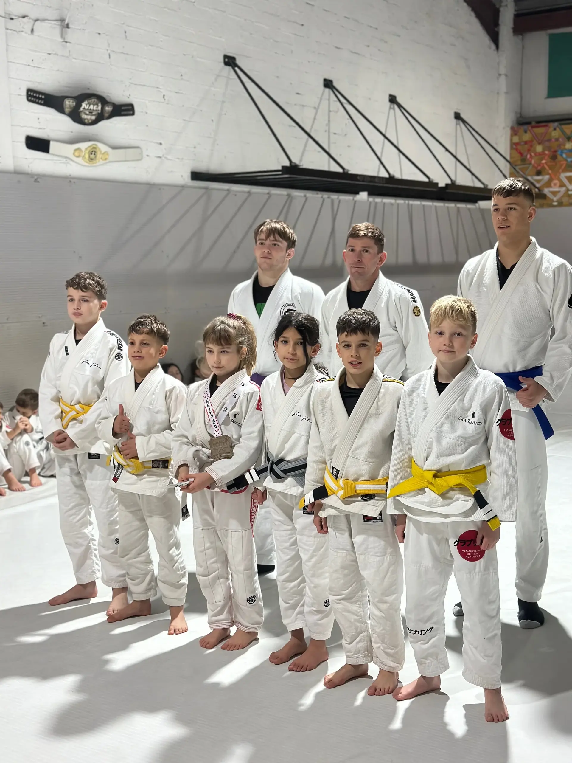 Students and instructors celebrating belt promotions at Studio Galera BJJ graduation in Bandon, West Cork 6